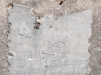 Heart with Randy, various letters and a swastika, C, EY, Billy. Chicago lakefront stone carvings, Calumet Park. 2024