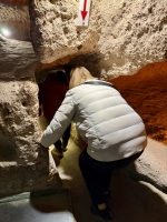 Entering a tight fit. Kaymakli underground city.