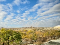 In the distance, Uçhisar Castle, a rock formation fortified by the Romans.