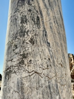 Graffitied pillar with inscription and creature