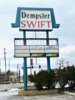 This odd mixture of a mansard shape and a flip hairdo outlasted the dead strip mall it promoted. There\'s a Target there now. Dempster Swift, Skokie, Illinois. Named for the nearby Skokie Swift train station. 2010