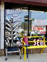 Muffler tree and another muffler man relaxing at 6 Stars Auto Body in July 2014. Lawrence Avenue near Sacramento, Chicago