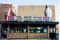 Pig Outs, Addison at Milwuakee, Chicago. Pig Outs is gone. The hot dog and hamburger were salvaged, and painted brown, for a nightclub closer to downtown, but in 2012 were laying in a scrap heap behind the club. 1995