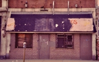 Remains of a hot dog stand, east 47th Street, Chicago. Note the ghost hot dog and hamburger on either side of the sign